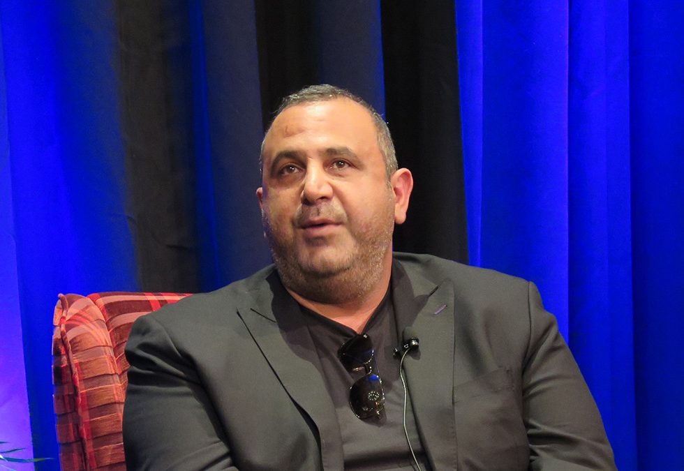 Sam Nazarian of C3 sits in a chair on stage at the Food On Demand Conference.